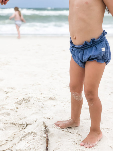 Our signature bloomers in the color Ocean playing in the sand.